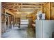 Inside the garage are exposed wood beams, shelving, and a refrigerator at 835 Pearleman Teague Rd, Siler City, NC 27344