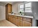 Galley kitchen featuring wooden cabinets and countertop with white appliances and a window providing natural light at 835 Pearleman Teague Rd, Siler City, NC 27344