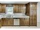 Kitchen with a stainless steel dishwasher, granite counters, and dark stained cabinets at 835 Pearleman Teague Rd, Siler City, NC 27344