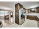 Open-concept kitchen with wood cabinets and stainless steel refrigerator at 835 Pearleman Teague Rd, Siler City, NC 27344