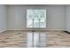 Spacious room featuring a large window and wood-look flooring at 835 Pearleman Teague Rd, Siler City, NC 27344
