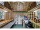 Interior shot of shed with wood ceilings and walls, shelving, work benches, and a fan at 835 Pearleman Teague Rd, Siler City, NC 27344