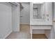 Walk-in closet featuring built-in shelving, carpet floors, and a vanity area at 835 Pearleman Teague Rd, Siler City, NC 27344