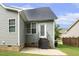 Back exterior of the home features gray siding, an exterior door, and a concrete patio area at 853 Bluffcreek Dr, Fuquay Varina, NC 27526