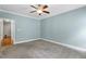 Carpeted bedroom with blue walls and a door opening to a closet at 853 Bluffcreek Dr, Fuquay Varina, NC 27526
