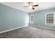 Spacious bedroom with light blue walls, ceiling fan, carpet, and windows at 853 Bluffcreek Dr, Fuquay Varina, NC 27526