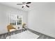 Relaxing bedroom features woven chairs, natural light and neutral walls and flooring at 853 Bluffcreek Dr, Fuquay Varina, NC 27526