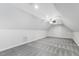 Bonus room features neutral walls and flooring, a fan, and natural light at 853 Bluffcreek Dr, Fuquay Varina, NC 27526