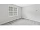 Bonus room featuring neutral walls and flooring and a window providing natural light at 853 Bluffcreek Dr, Fuquay Varina, NC 27526