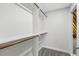 Walk-in closet features a custom shelving and hanging system, and neutral gray carpeted floor at 853 Bluffcreek Dr, Fuquay Varina, NC 27526