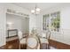 Dining room with hardwood floors, decorative trim, and natural light, ideal for Gathering gatherings at 853 Bluffcreek Dr, Fuquay Varina, NC 27526