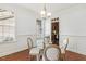 Bright dining room with hardwood floors, wainscoting, and a clear view into the adjacent kitchen at 853 Bluffcreek Dr, Fuquay Varina, NC 27526