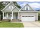 Charming home featuring a well-manicured lawn, covered porch, and two-car garage, blending comfort and curb appeal at 853 Bluffcreek Dr, Fuquay Varina, NC 27526