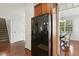 Modern black refrigerator stands out, offering easy access from the kitchen and adjacent dining area at 853 Bluffcreek Dr, Fuquay Varina, NC 27526
