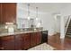 This kitchen boasts granite countertops, a tiled backsplash, and rich wood cabinets, perfect for culinary endeavors at 853 Bluffcreek Dr, Fuquay Varina, NC 27526