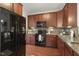 This kitchen boasts granite countertops, updated appliances, and ample cherry wood cabinet space at 853 Bluffcreek Dr, Fuquay Varina, NC 27526