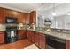 Gourmet kitchen with granite counters, stainless appliances, and rich wood cabinets seamlessly connects to the living area at 853 Bluffcreek Dr, Fuquay Varina, NC 27526