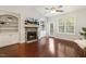 The sunlit living room features vaulted ceilings, a cozy stone fireplace, and built-in shelving at 853 Bluffcreek Dr, Fuquay Varina, NC 27526