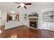Inviting living room boasts a stone fireplace, built-in bookcases, and an open layout connected to the kitchen at 853 Bluffcreek Dr, Fuquay Varina, NC 27526