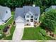 Lovely two-story home boasts a spacious driveway and a lush front lawn, complemented by mature trees and landscaping at 8841 Deerland Grove Dr, Raleigh, NC 27615
