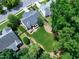 Beautiful backyard oasis featuring a lush lawn, a dining deck, mature trees, and manicured landscaping at 8841 Deerland Grove Dr, Raleigh, NC 27615