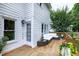 Back deck featuring outdoor seating, flower pots, string lights, and access to the backyard at 8841 Deerland Grove Dr, Raleigh, NC 27615