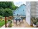 Outdoor deck area with a dining table, chairs, and lush surroundings, perfect for entertaining at 8841 Deerland Grove Dr, Raleigh, NC 27615