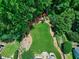 Lush backyard featuring expansive green space, bordering trees, and a ' playset creating the ultimate outdoor escape at 8841 Deerland Grove Dr, Raleigh, NC 27615