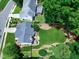 Lush backyard featuring a garden, a playground, mature trees, and a deck perfect for outdoor living and entertaining at 8841 Deerland Grove Dr, Raleigh, NC 27615