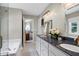 Bright bathroom features a double vanity with marble countertop, tub, and glass shower at 8841 Deerland Grove Dr, Raleigh, NC 27615