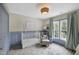 Charming Bedroom with blue accents, a white crib, and a comfortable sitting area at 8841 Deerland Grove Dr, Raleigh, NC 27615
