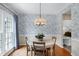 Charming dining room with wallpaper, pendant lighting, and a view into the kitchen at 8841 Deerland Grove Dr, Raleigh, NC 27615