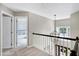 Upstairs foyer looking into a bedroom, features a decorative light fixture at 8841 Deerland Grove Dr, Raleigh, NC 27615