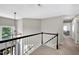 Upstairs foyer features a decorative light fixture and a view of the front entrance at 8841 Deerland Grove Dr, Raleigh, NC 27615