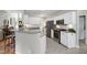 Modern kitchen featuring white cabinets, granite countertops, stainless steel appliances and tiled floors at 8841 Deerland Grove Dr, Raleigh, NC 27615