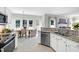 A kitchen with stainless steel appliances, granite countertops, and an open view to the dining area and living room at 8841 Deerland Grove Dr, Raleigh, NC 27615