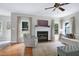 Bright living room with hardwood floors, fireplace, and comfortable seating at 8841 Deerland Grove Dr, Raleigh, NC 27615