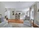 Bright and open living room with hardwood floors flows into the kitchen and dining area for a cohesive living space at 8841 Deerland Grove Dr, Raleigh, NC 27615