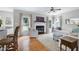 Cozy living room with a fireplace, hardwood floors, and a ceiling fan at 8841 Deerland Grove Dr, Raleigh, NC 27615