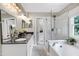 Spacious main bathroom with double sink vanity, soaking tub, and glass-enclosed shower at 8841 Deerland Grove Dr, Raleigh, NC 27615
