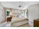 Inviting main bedroom with plush bedding, neutral decor, and natural light from surrounding windows at 8841 Deerland Grove Dr, Raleigh, NC 27615