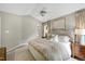 Well-lit main bedroom with ceiling fan, neutral decor, and natural light from surrounding windows at 8841 Deerland Grove Dr, Raleigh, NC 27615