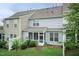 Backyard view showcasing a screened-in porch and lush green space at 9 Moss Side Ter, Durham, NC 27703