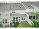 The backyard is fenced and has a screened in porch surrounded by green bushes at 9 Moss Side Ter, Durham, NC 27703