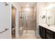 Modern bathroom featuring a glass shower, tile floors, and a sleek vanity with ample counter space at 9 Moss Side Ter, Durham, NC 27703