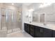 Bathroom with dual sinks, shower, and tile flooring at 9 Moss Side Ter, Durham, NC 27703