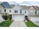 Inviting townhouse showcasing colorful exteriors, a two-car garage, and manicured lawns at 9 Moss Side Ter, Durham, NC 27703