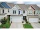 Charming townhome featuring an attached garage, and eye-catching exterior color scheme at 9 Moss Side Ter, Durham, NC 27703