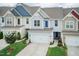 Charming townhouse featuring a two-car garage and well-maintained landscaping at 9 Moss Side Ter, Durham, NC 27703