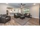 Spacious living room with leather sofas, ceiling fan, and view of the kitchen at 9 Moss Side Ter, Durham, NC 27703